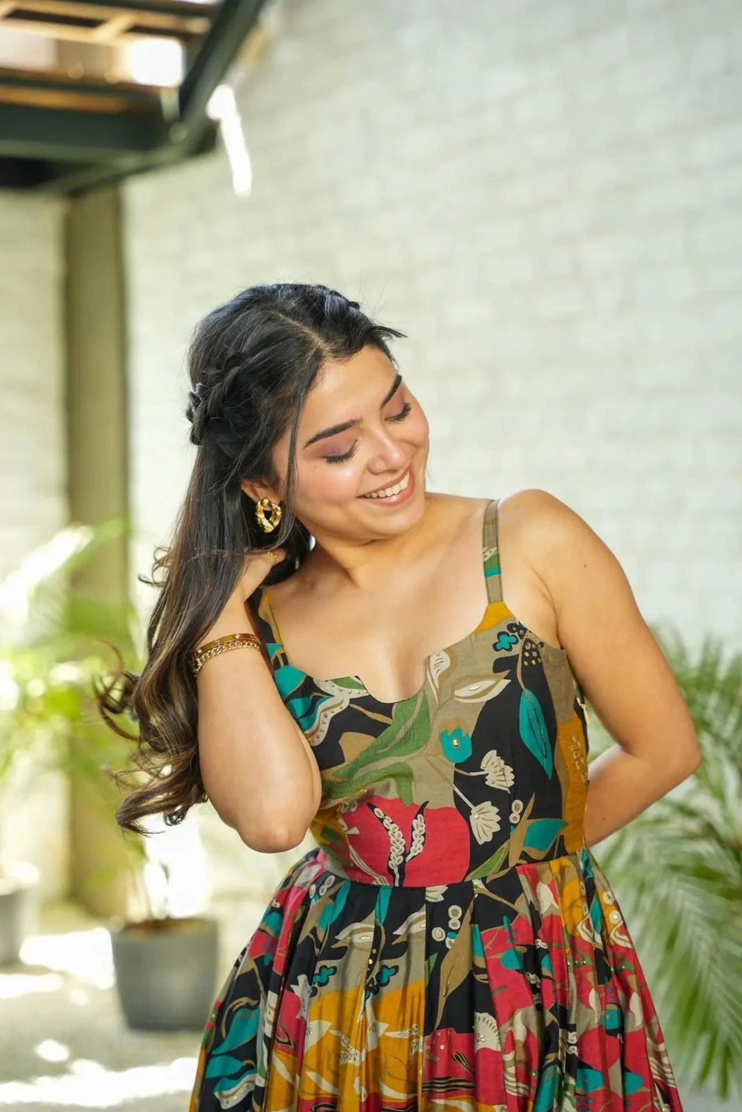 Woman wearing a colorful patterned dress in an outdoor setting